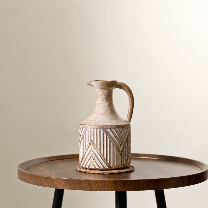 Antique Ceramic Vase on a wooden table, featuring a sleek modern design with geometric patterns, perfect for adding a statement touch to any space. Nest Haven Shop, CERAMIC, LIVING ROOM