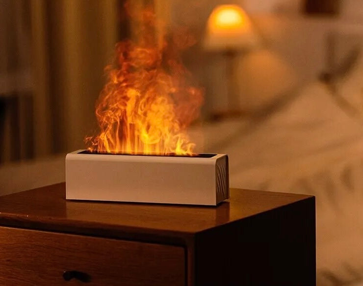 Modern white Fireplace Diffuser emitting colorful flame simulation, creating a relaxing ambiance on a wooden nightstand in a cozy bedroom setting - NestHaven Shop, Home page