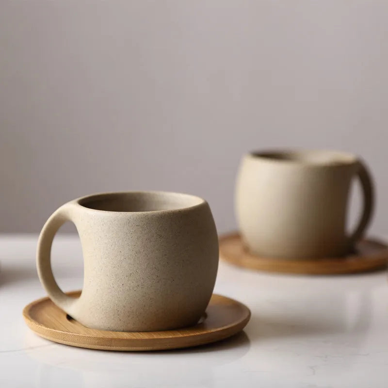 Stylish ceramic coffee cup with wooden saucer, perfect for a cozy coffee moment or a chic decor touch. Available at Nest Haven Shop, KITCHEN.