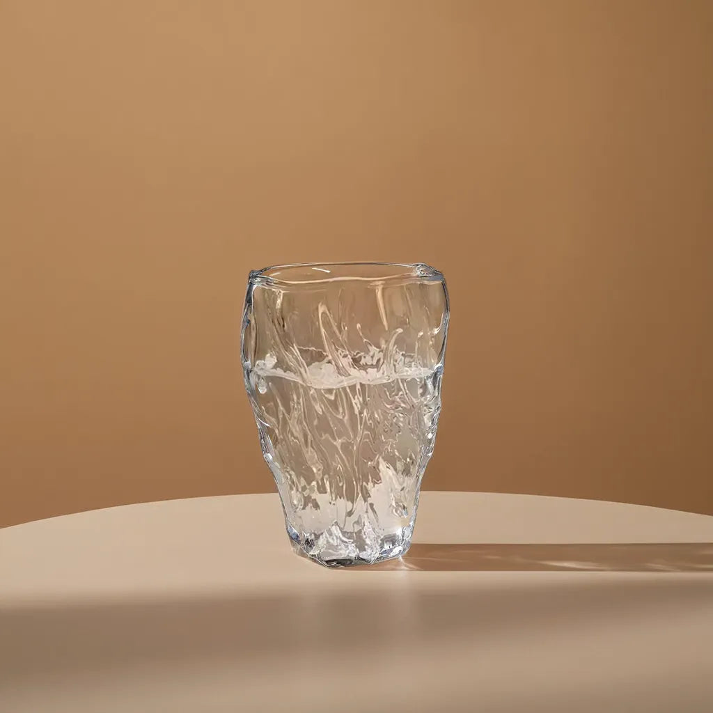 Elegant Crystal Wave Glass with a unique rippled design, perfectly capturing the essence of flowing water. 10 oz capacity, ideal for stylish drinkware enthusiasts. Nest Haven Shop, GLASS, KITCHEN.