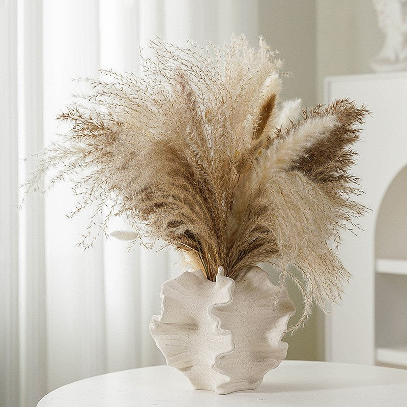 Unique Ceramic Coral Vase with swirling patterns filled with pampas grass, perfect for adding whimsy and elegance to any living room. Nest Haven Shop, CERAMIC, LIVING ROOM